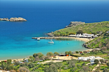 Panoramic view of Lindos sand beach and fishing port. Rhodes island, Greece.