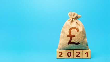 British pound sterling money bag and blocks 2021. Budget planning for next year. Beginning of new...
