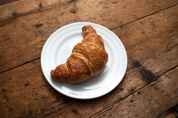 croissants on a plate over wooden table