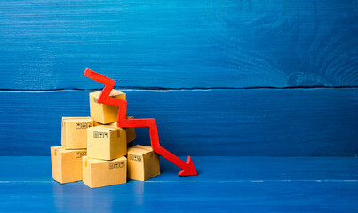 Cardboard boxes and red down arrow. Fall in sales and production of goods, low volume of delivery...