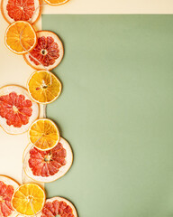 Healthy food concept. Frame of mixed dried fruit and vegetable chips, candied pumpkin slices, nuts and seeds on white marble background with blank space for text. Top view, flat lay.