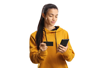 Young woman shopping online with a credit card and a smartphone