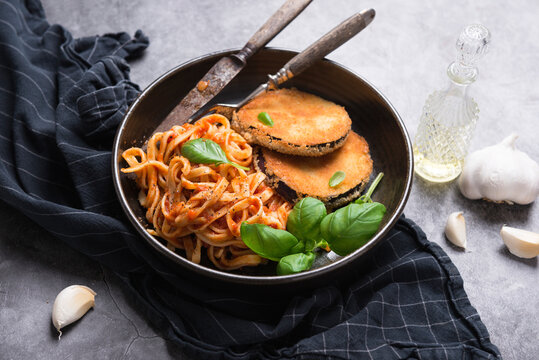 Aubergine cutlet with ribbon pasta in tomato sauce