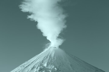 Winter eruption active volcano, plume from crater steam, gas, ashes. Volcanic landscape coloring in...