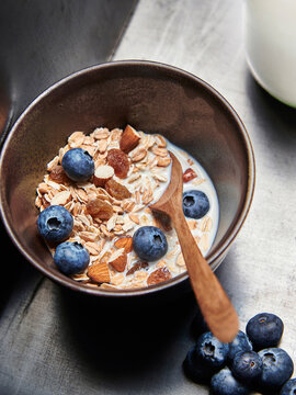 Muesli made from oatmeal, raisins, almonds, blueberries and milk