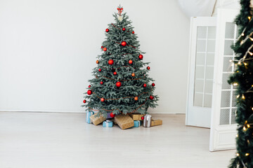 Beautiful holdiay decorated room with Christmas tree with presents under it