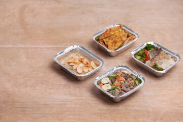 take away lunch boxes with fresh meal in foil container or healthy food delivery