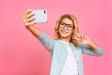 Portrait of positive cheerful wavy hair model kid have fun on leisure trip take selfie video call...