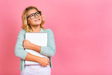Fototapeta premium Excited little blonde teenager kid girl 12-13 years old isolated over pink background. Childhood lifestyle concept. Mock up copy space.