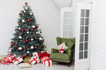 Beautiful holdiay decorated room with Christmas tree with presents under it
