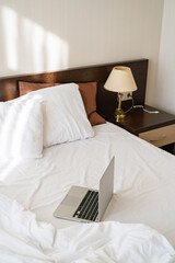 laptop is on the bed in the hotel room