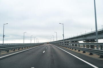 Empty highway with asphalt road and cloudy sky