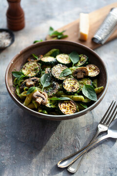 Pasta with zucchini, mushrooms, pesto and basil
