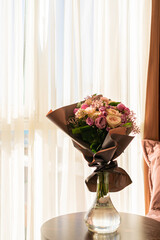 there is a vase of flowers on the table in the room