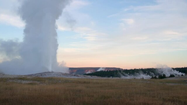 Old faithful at erupting at dawn with no one around. Time lapse.