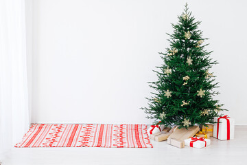 Beautiful holdiay decorated room with Christmas tree with presents under it. New year background