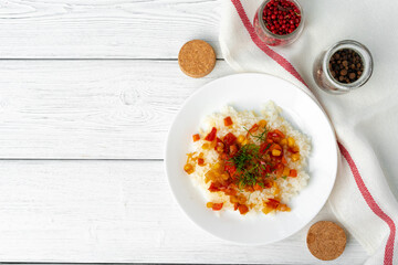 Prepared rice with vegetables on white wooden table