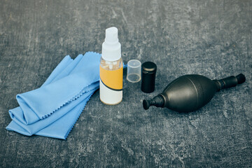 Optics cleaning accessories, cleaning liquid, rubber bulb and microfiber cleaning cloth, shallow depth of sharpness