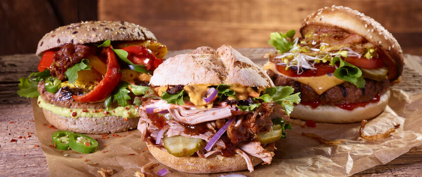 Three different hamburgers on paper