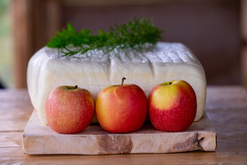 a large fresh cheese with herbs and apples