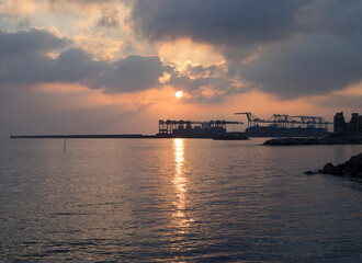 sihlouette of Big port cranes at sunset