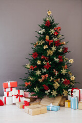 decorated room with Christmas tree with presents under it