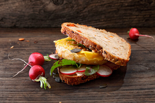A sandwich with celeriac, radishes and cheese