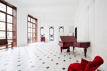 Huge luxury white hall with unique interior. Black and white tiles on the floor, white and black...