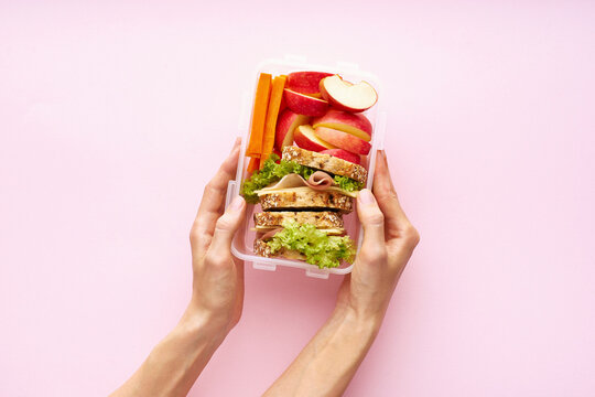 Woman holding lunch box with healthy nutritious meal