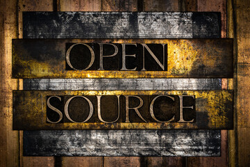 Open Source text formed by real authentic typeset letters on vintage textured grunge bronze background