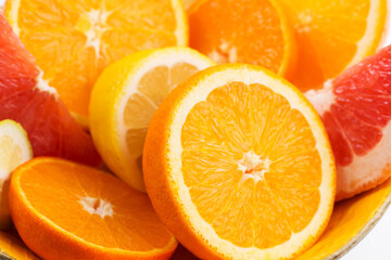 Whole and sliced orange fruit on white background