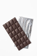 Black bar of chocolate isolated on white