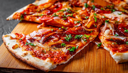 slice of Pizza with chicken and barbeque sauce. Italian pizza on Dark grey black slate background