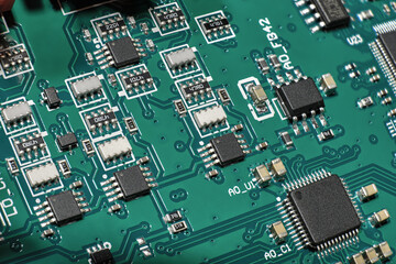 Green PCB closeup macro shot with different surface mount chips, SMD resistors and capacitors high...