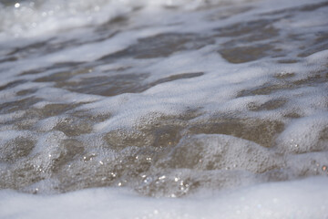 Fototapeta na wymiar a foam wave of the north sea breaking on the beach 