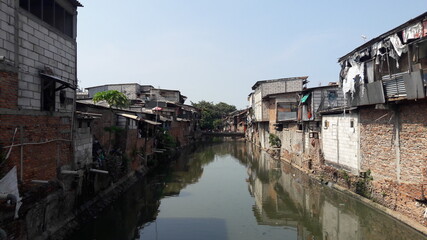 Fototapeta na wymiar Slum area located on the banks of a dirty river