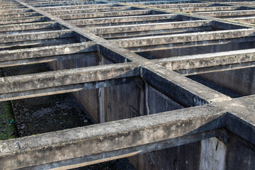 old sewage treatment plant, concrete structure, settling tanks
