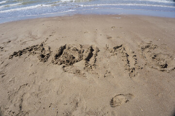 high school graduation 2016 lettering in the sand on the beach
