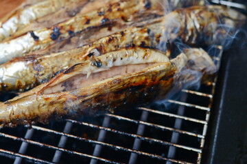 Barbecue with fish. Grilled mackerel fish. Fatty, oily fish is an excellent and healthy source of DHA and EPA, which are two key types of omega-3 acid.
