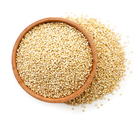 Quinoa in a wooden plate on a white background, isolated. The view from top