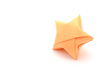 An orange folded paper star