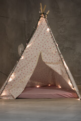 Handmade tent for children with decorative lights. © Marko