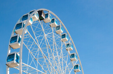 Ferris wheel high against the blue sky