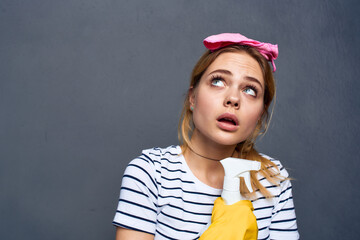 Cleaning lady with detergent pink rag service lifestyle cropped view 