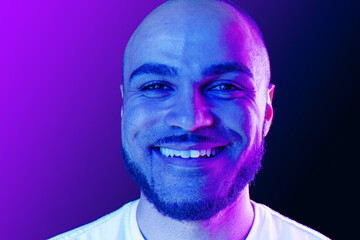 Close up portrait of a black man in purple neon light