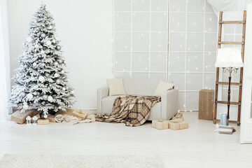 Home interior. A room with a beautiful snowy Christmas tree and gifts under this tree.