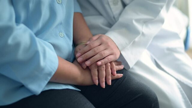 Close up hands of doctor  and cancer patient  consulting in hospital