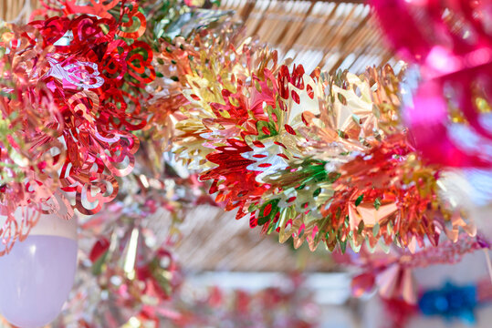 Colorful festive decoration shiny garland at sunset light.