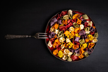 Colorful Italian pasta on a wooden rustic background.
