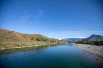 Scenic image of fairy-tale Landscape with colorful overcast sky under sunlit, over the Mountain Lake. Megical Natural Background. Amazing lake in sunset. Creative image. Strbske Pleso. Slovakia. Tatra